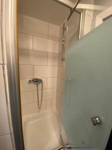 a bathroom with a shower and a white tub at Apartment in Herne 4 in Herne