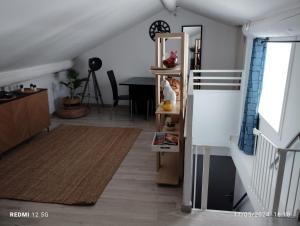 a living room with a staircase and a table at Un nid sur les toits avec terrasse in Apt