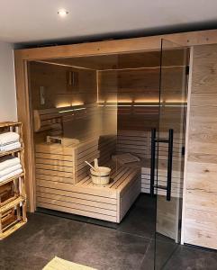 a sauna with a glass wall in a room at Moselhotel Weinhaus Simon in Wintrich