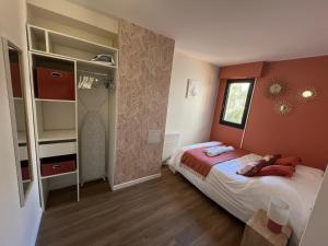 a small bedroom with a bed and a window at Les jardins de la Méditerranée in Six-Fours-les-Plages
