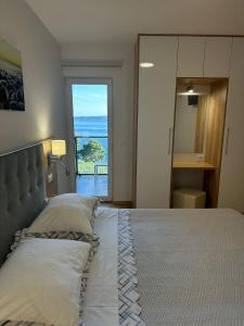 a bedroom with a bed with a view of the ocean at Apartment Ante in Brela