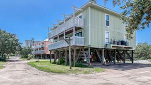a large building with stairs up to it at Romar Village 322- short walk to beach pool in Orange Beach