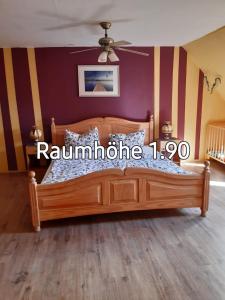 a bedroom with a wooden bed with a purple wall at Apartments zum Brauergang in Garz-Rügen