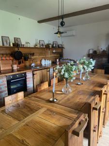 a large wooden table in a kitchen with candles on it at Marijini dvori in Čadjavica +44 photos