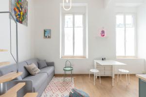a living room with a couch and a table at Appartement moderne in Marseille +12 photos