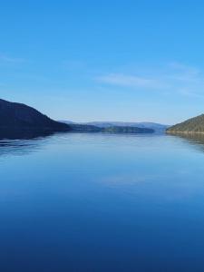 a large body of water with a blue sky at Ferienhaus Solli Norwegen inkl Boot in Kolvereid +2 photos