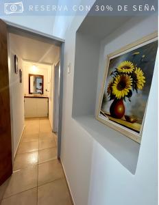a hallway in a house with a painting on the wall at Residencia Céntrica in Chilecito