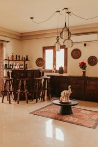 a living room with a table and a kitchen at Maya pool & mountain view villa in Koskinou +37 photos