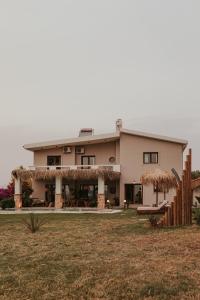 a large house with a grass at Maya pool & mountain view villa in Koskinou