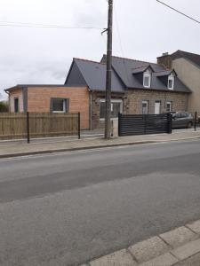 a house on the side of a street with a fence at La casa d'isa in Ducey