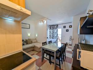 a kitchen and a living room with a table and chairs at Studio Playa Paraiso Tenerife - ocean view and internet wifi optical fiber - for rent in Playa Paraiso