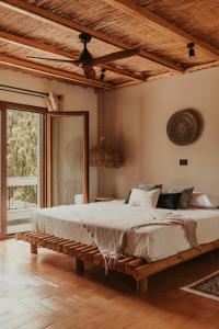 a large bed in a room with a wooden ceiling at Maya pool & mountain view villa in Koskinou
