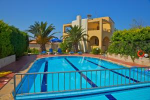 a swimming pool in front of a house at Aloni Villas in Roussospítion