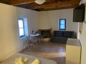 a living room with a couch and a table at Kalamitsi House 2 in Agia Pelagia