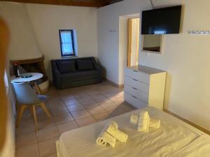 a living room with a bed and a couch at Kalamitsi House 2 in Agia Pelagia