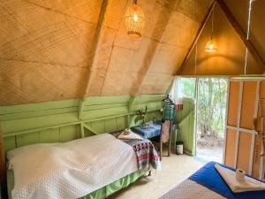 a bedroom with a bed in a tent at Unicorn Reborn - Peaceful Rentals in San Marcos La Laguna