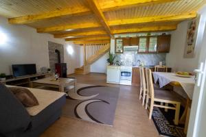 a kitchen and living room with a couch and a table at Vikendica Anastasija in Laktaši