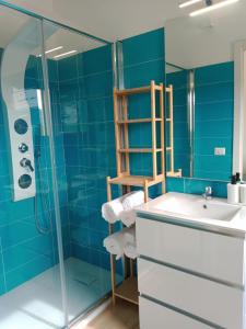 a blue bathroom with a sink and a shower at La Grotta Sardegna 5 Bedrooms each with a Private Ensuite Bathroom featuring a Hydromassage Shower Air Conditioning in Urzulei