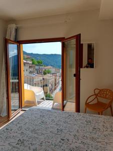 a bedroom with a bed and a view of a balcony at La Grotta Sardegna 5 Bedrooms each with a Private Ensuite Bathroom featuring a Hydromassage Shower Air Conditioning in Urzulei