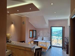 a hotel room with a bed and a balcony at Holiday Home Sunny Hill in Kamenari