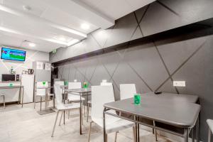 une salle à manger avec des tables et des chaises blanches dans l'établissement City Inn Paris, à Paris