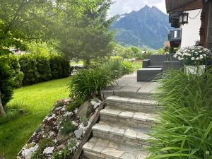a garden with a stone path leading to a house at Chalet Charlotte in Fusch an der Glocknerstraße
