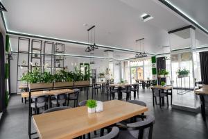 a restaurant with tables and chairs and plants at Edelweiss New 2026 Солотвино in Solotvyno