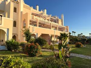 a large building with a lot of plants at Diletta Beach Estepona in Estepona