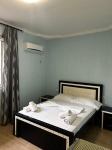 a bedroom with a bed with two towels on it at Villa AlMar in Sarandë
