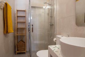 a bathroom with a shower and a toilet and a sink at Casa da Portela, Algarve Tradicional - Geoparque Algarvensis in São Bartolomeu de Messines +18 photos