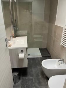 a bathroom with a sink and a toilet and a shower at Monolocale Pura Vida in Viareggio
