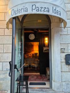 an entrance to a pizza store with a table in the window at Elena House Apartments in Viareggio