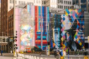 a large mural of two women on a building at Sonder at North Loop Green in Minneapolis