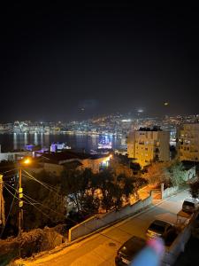 a view of a city at night at Villa AlMar in Sarandë