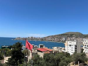a view of a city with a red flag at Villa AlMar in Sarandë