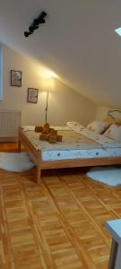 a large bed in a room with a wooden floor at Apartman "Andjela" in Belgrade