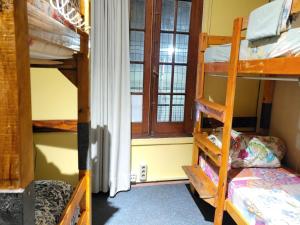 a room with two bunk beds and a window at Montevideo Hostel in Montevideo