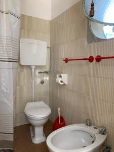 a small bathroom with a toilet and a sink at Hotel Garni Picnic in Riccione