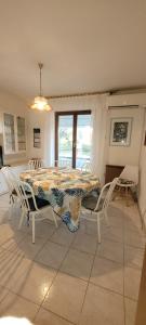 a dining room with a table and white chairs at Panoramic view near the beach in Portotož+P in Portorož