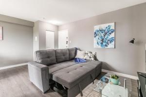 a living room with a couch and a table at 2BR Apt - Near Downtown Hamilton - Sleeps 6 in Hamilton +13 photos