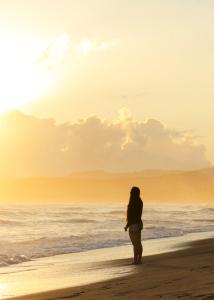 a woman standing on the beach looking at the ocean at Surf and Yoga Retreat for Groups Near Cab! in Gaspar Hernández