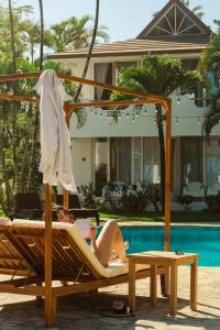 a woman laying in a hammock next to a pool at Surf and Yoga Retreat for Groups Near Cab! in Gaspar Hernández