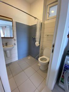 a bathroom with a toilet and a sink at WissaHomeZanzibar in Dambani
