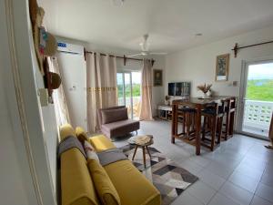 a living room with a yellow couch and a table at WissaHomeZanzibar in Dambani