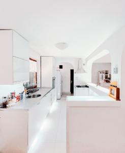 a white kitchen with white counters and white appliances at Vila Avala in Belgrade