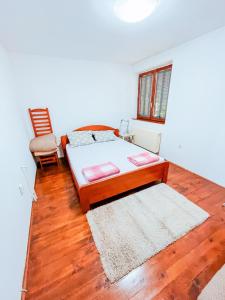 a bedroom with a bed and a chair in it at Vila Avala in Belgrade