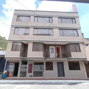 a building on the corner of a street at Rossy House in Baños