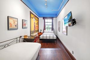 a room with two beds and a blue ceiling at Chelsea Pines Inn in New York