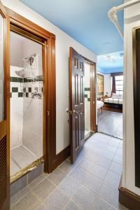 a bathroom with a shower and a glass door at Chelsea Pines Inn in New York