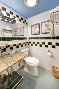 a bathroom with a toilet and a sink at Chelsea Pines Inn in New York